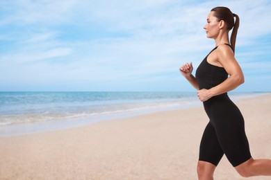 Image of Beautiful woman running on beach. Space for text