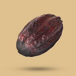 Image of Cocoa pod in air on dark beige background