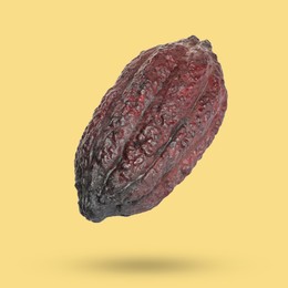 Image of Cocoa pod in air on yellow background