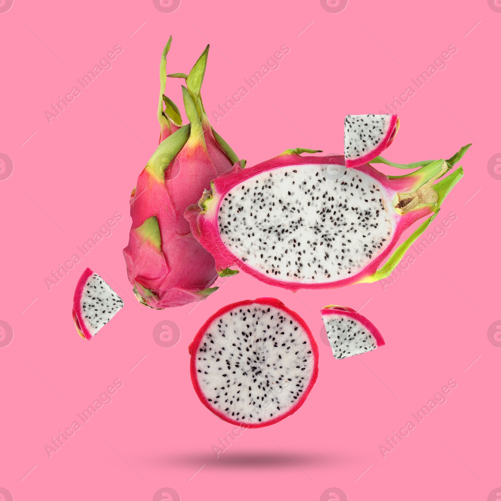 Image of Yummy pitaya fruits falling on pink background