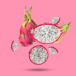 Image of Yummy pitaya fruits falling on pink background