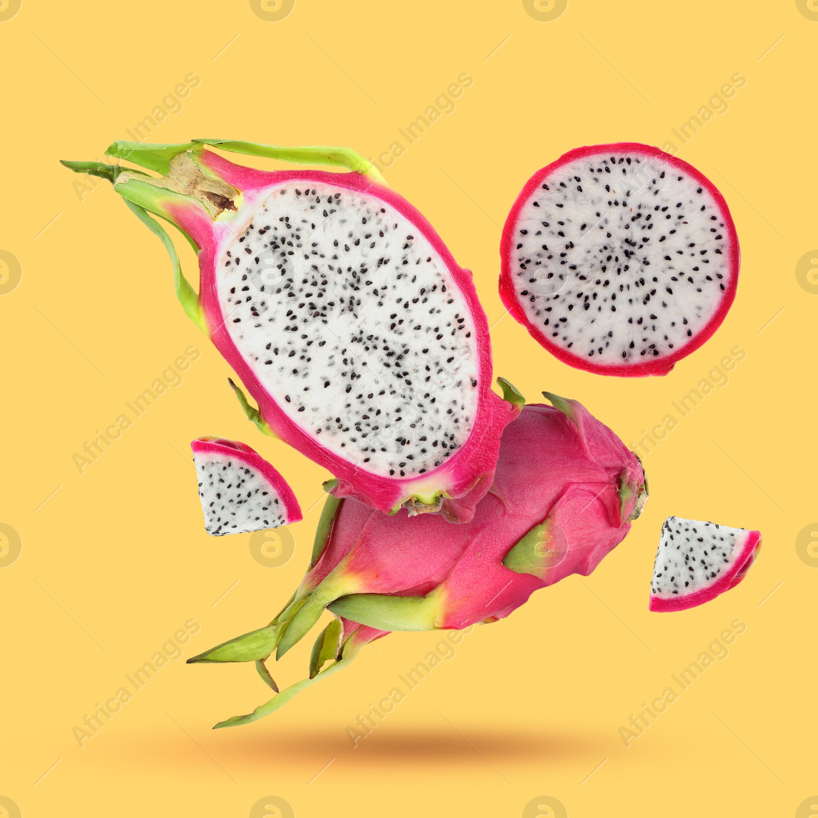 Image of Yummy pitaya fruits falling on orange background