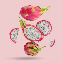 Image of Yummy pitaya fruits falling on pink background