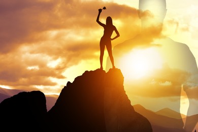 Image of Winner with trophy cup in mountains at sunrise and silhouette of man