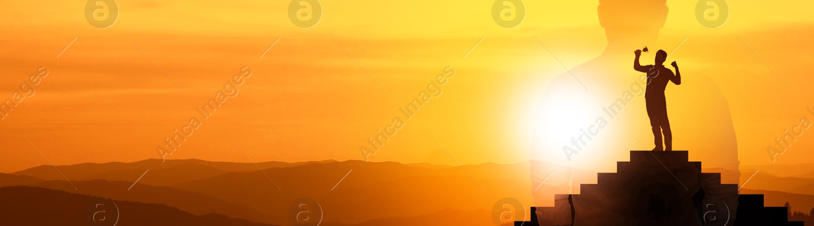 Image of Winner with trophy cup on podium in mountains at sunrise and silhouette of man. Banner design