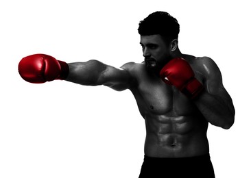 Image of Man in red boxing gloves training on white background. Black-and-white effect with color accent