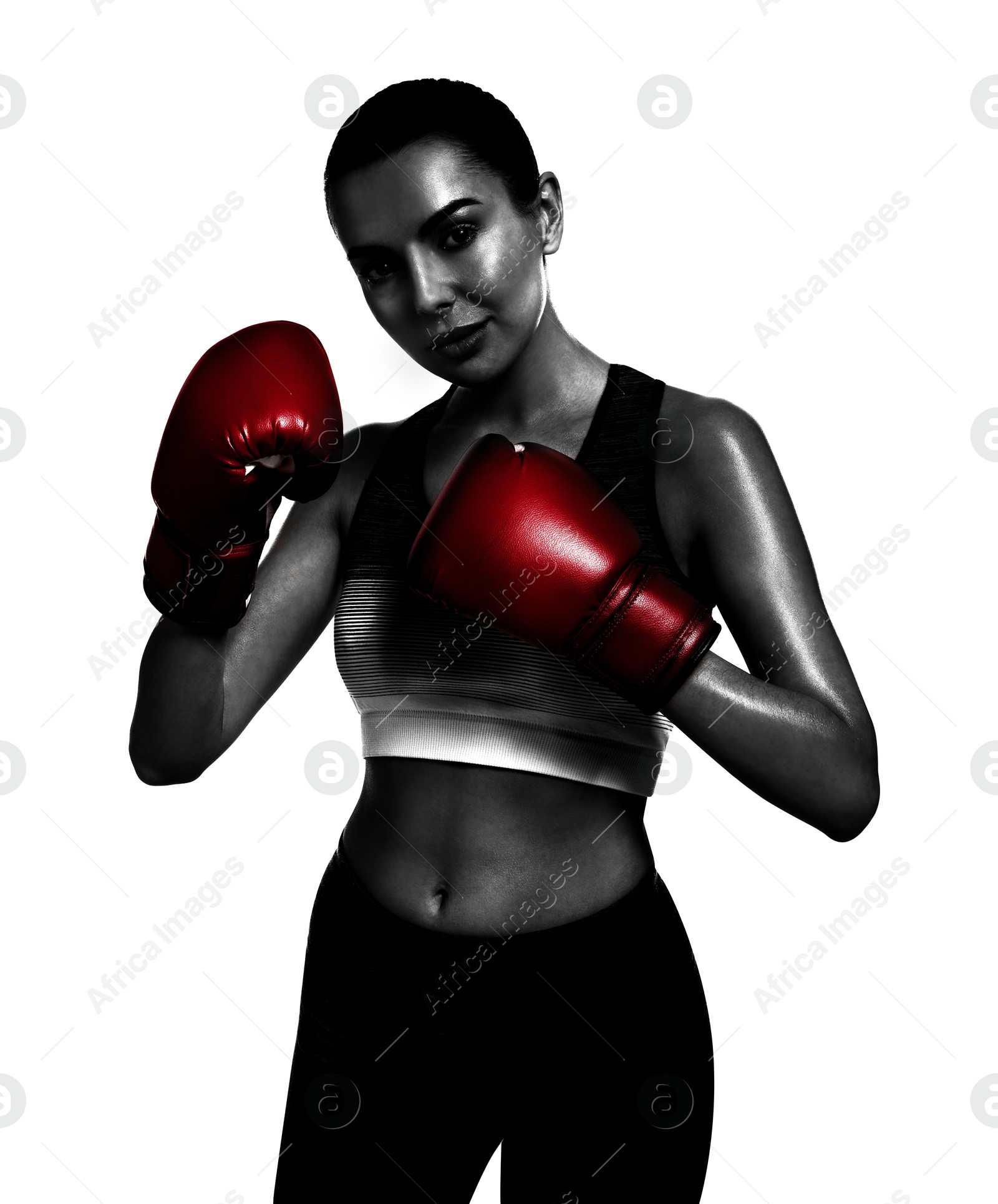 Image of Woman in red boxing gloves on white background. Black-and-white effect with color accent