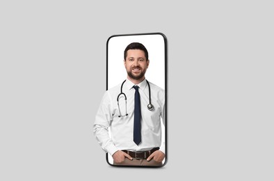 Image of Online medical consultation. Doctor on smartphone screen against light grey background