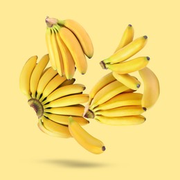 Image of Many fresh bananas falling on yellow background