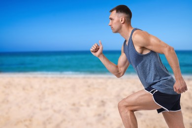 Image of Sporty man running on beach. Space for text