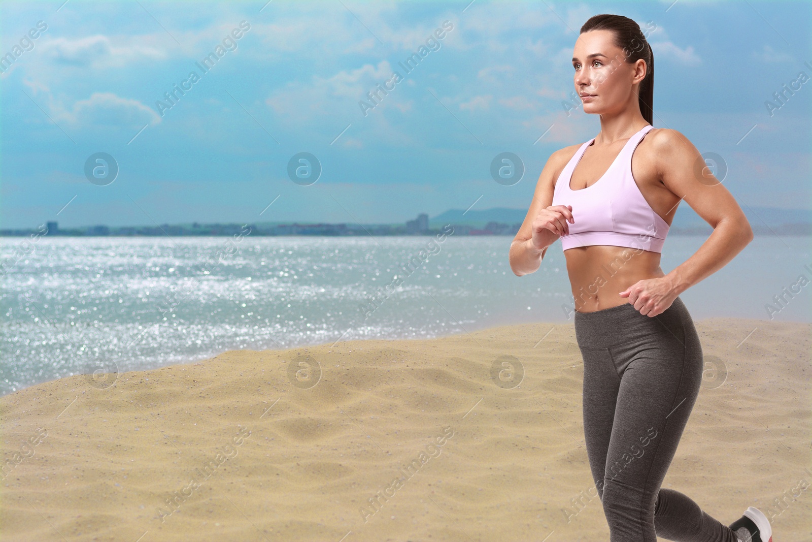 Image of Beautiful woman running on beach. Space for text