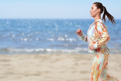 Image of Beautiful woman running on beach. Space for text