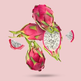 Image of Yummy pitaya fruits falling on pink background