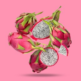 Image of Yummy pitaya fruits falling on pink background