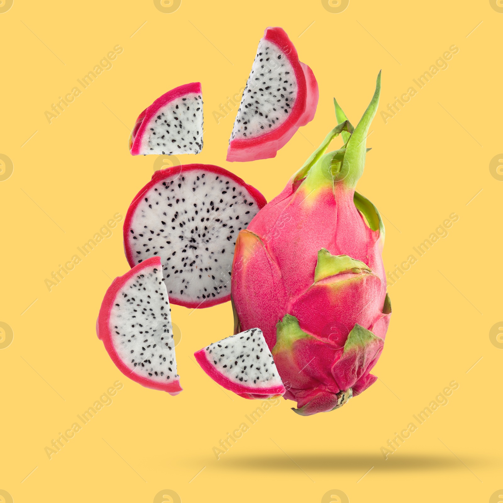 Image of Yummy pitaya fruits falling on orange background