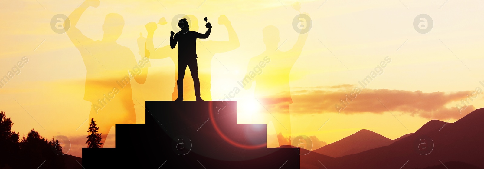 Image of Winner with trophy cup on podium in mountains at sunrise and silhouettes of people. Banner design