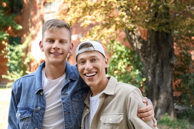 Photo of Family portrait of happy brothers outdoors on sunny day