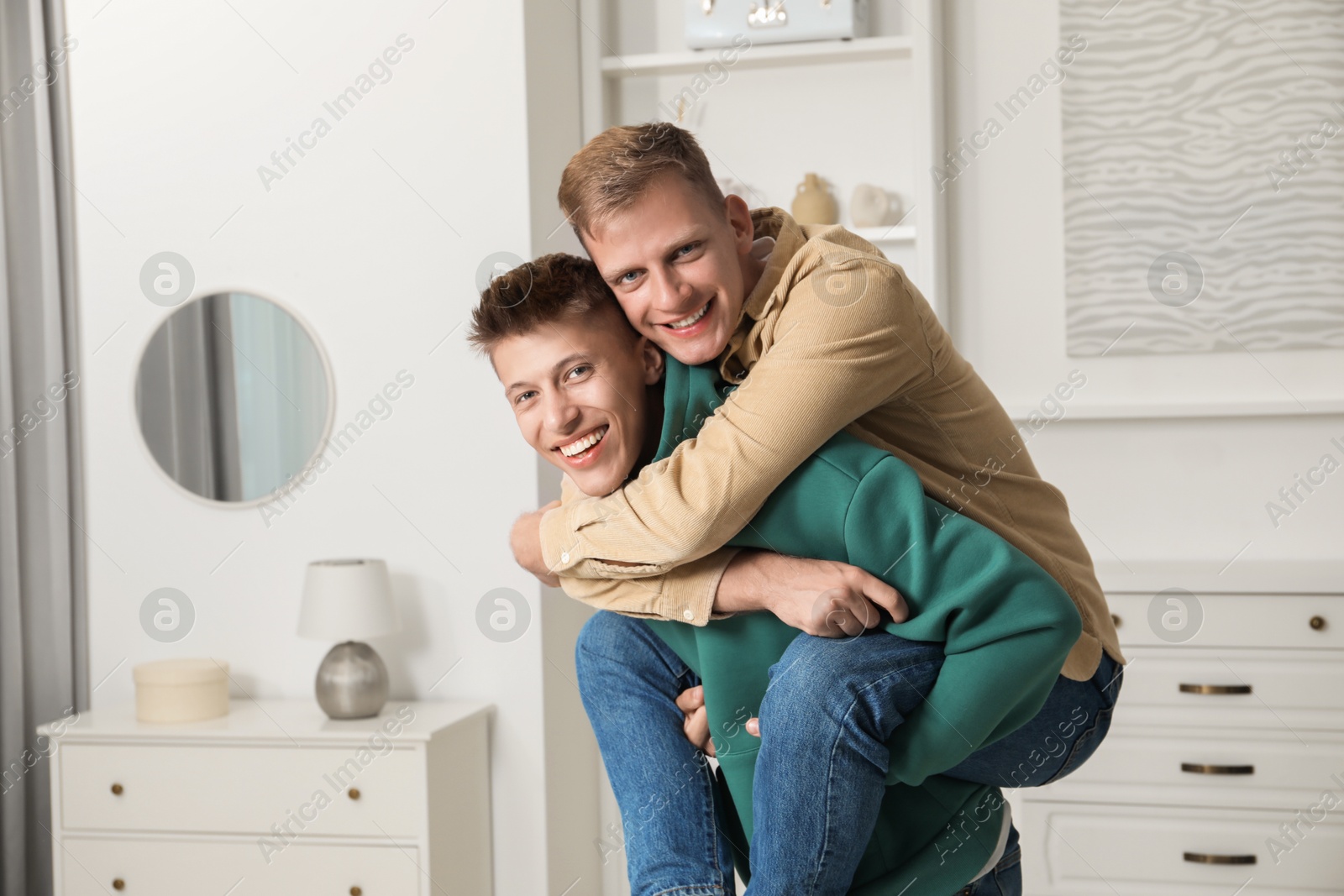 Photo of Family portrait of happy brothers having fun at home