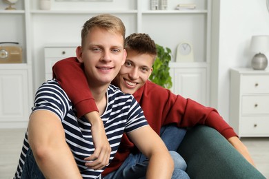 Photo of Family portrait of happy brothers at home