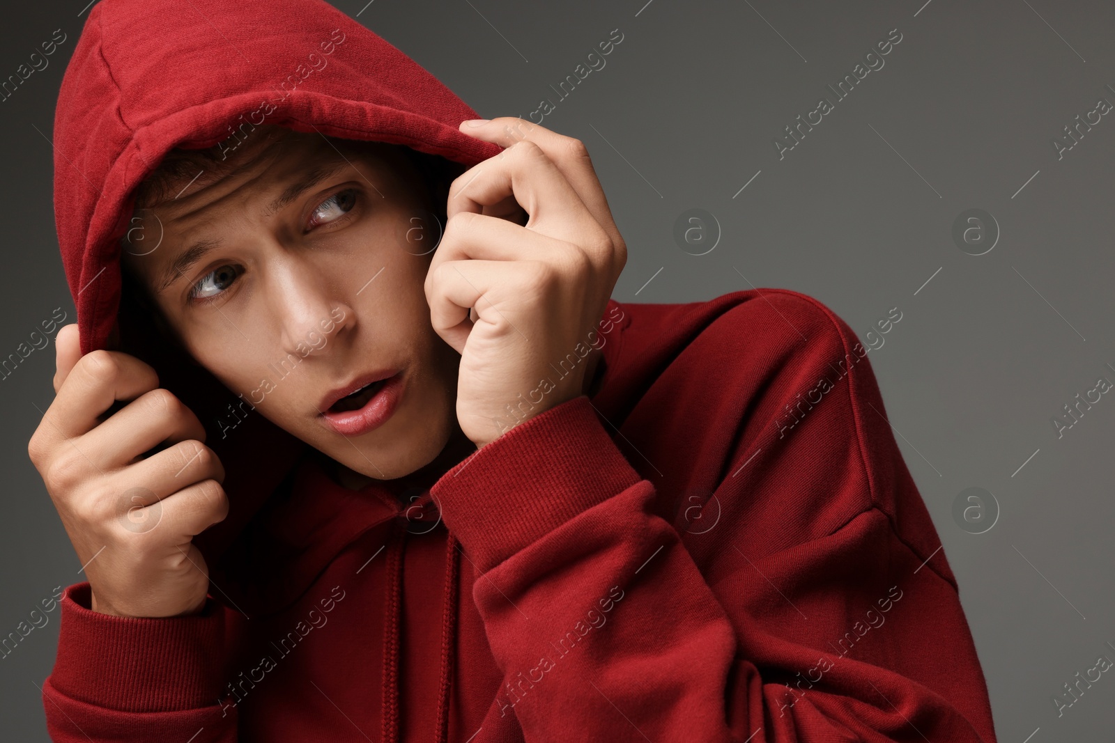 Photo of Portrait of scared young man on gray background