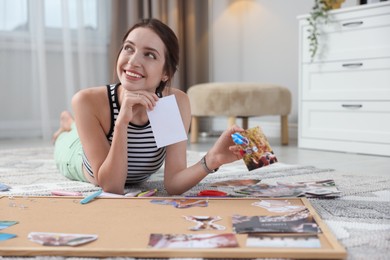 Woman creating vision board with different photos and other elements on floor indoors