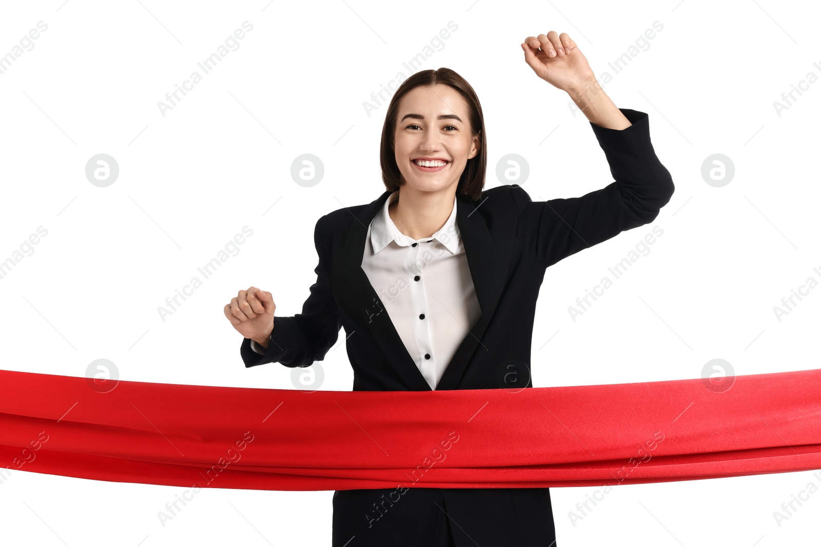 Photo of Young businesswoman in suit crossing red finish line on white background