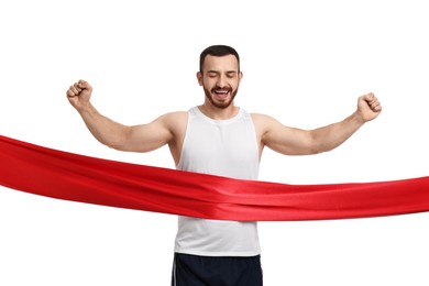 Handsome young man crossing red finish line on white background