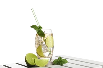 Photo of Glass of tasty refreshing drink with straw and fresh fruit on wooden table against white background