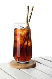 Photo of Glass of tasty refreshing drink and straws on wooden table against white background