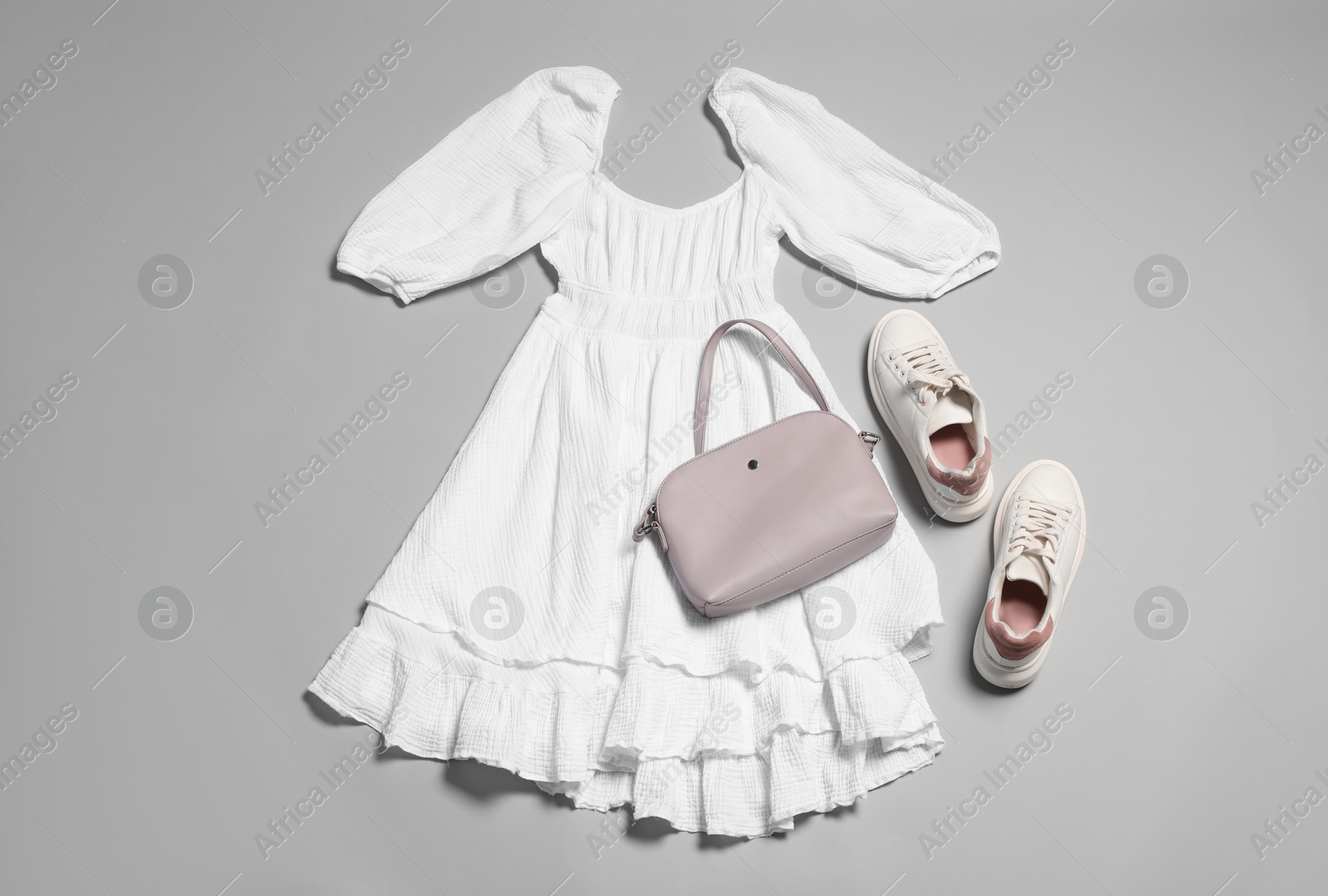 Photo of Stylish outfit with bag on light grey background, flat lay