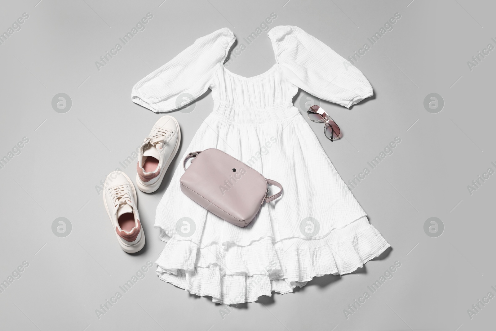 Photo of Stylish outfit with bag on light grey background, flat lay