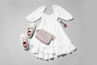 Photo of Stylish outfit with bag on light grey background, flat lay