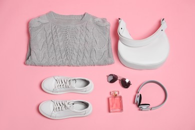 Photo of Stylish outfit with bag on pink background, flat lay