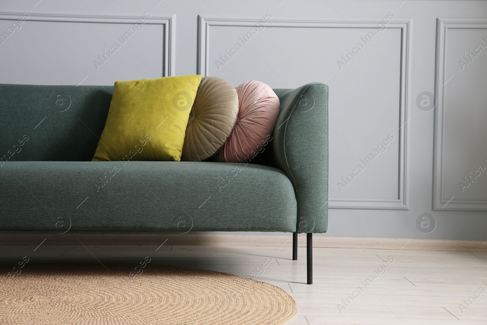 Photo of Comfortable sofa near grey wall in room