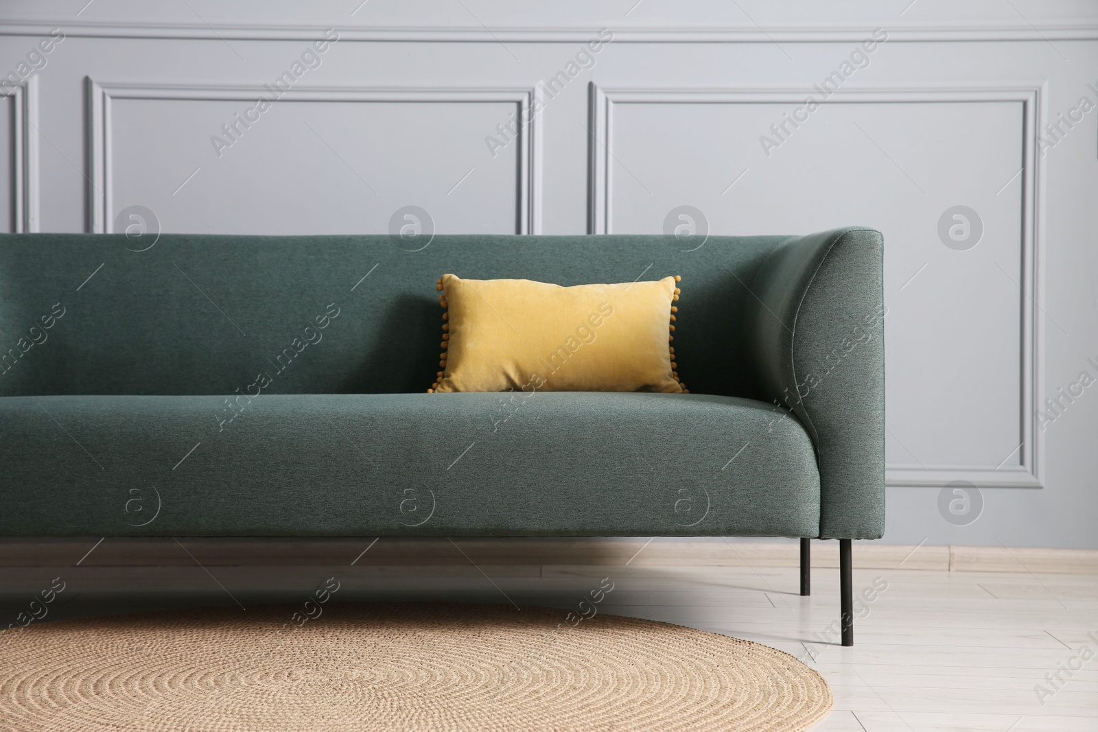 Photo of Comfortable sofa near grey wall in room