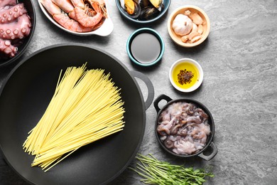 Photo of Ingredients for wok on grey table, flat lay