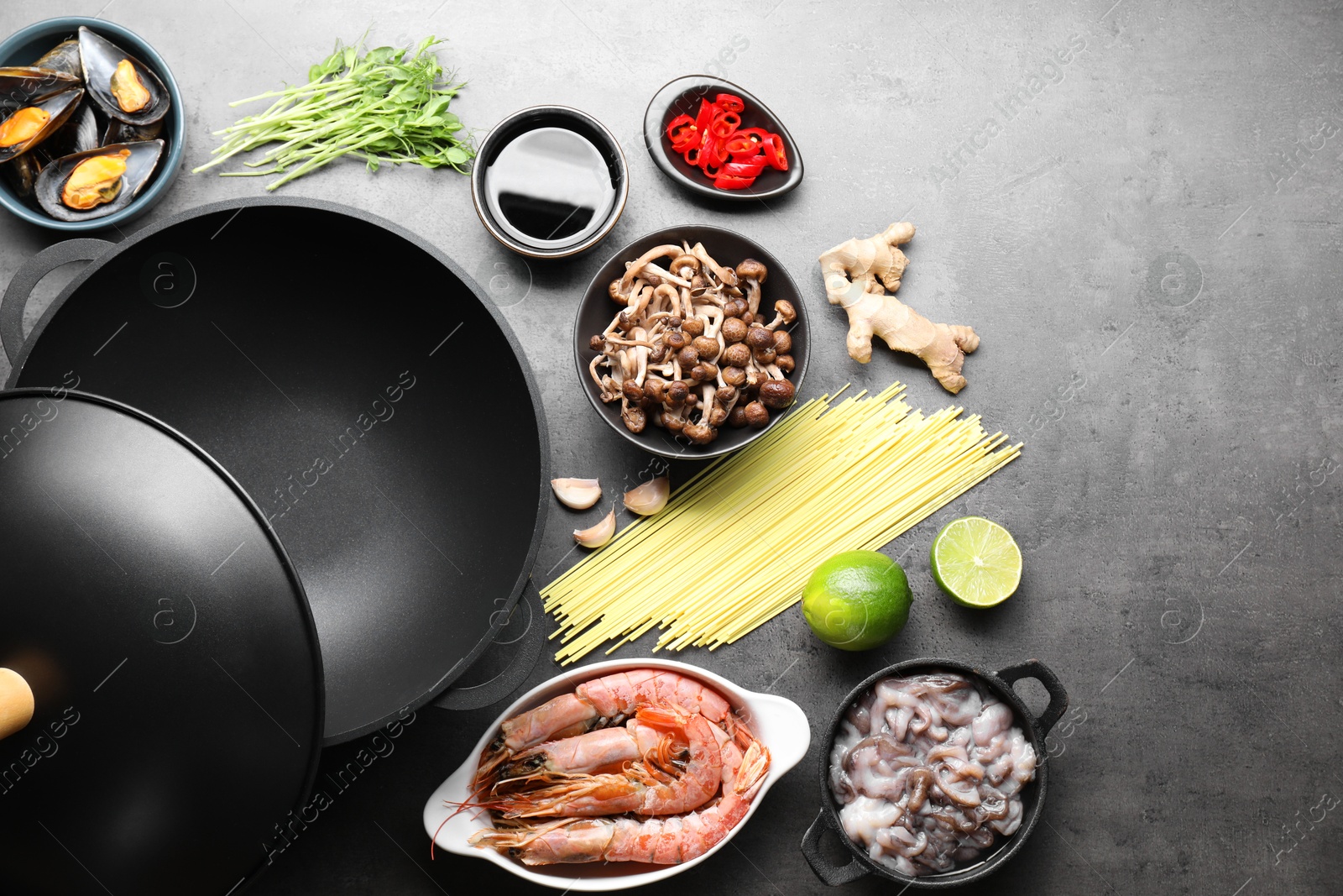 Photo of Ingredients for wok on grey table, flat lay