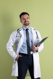 Smiling doctor with stethoscope and clipboard on olive background