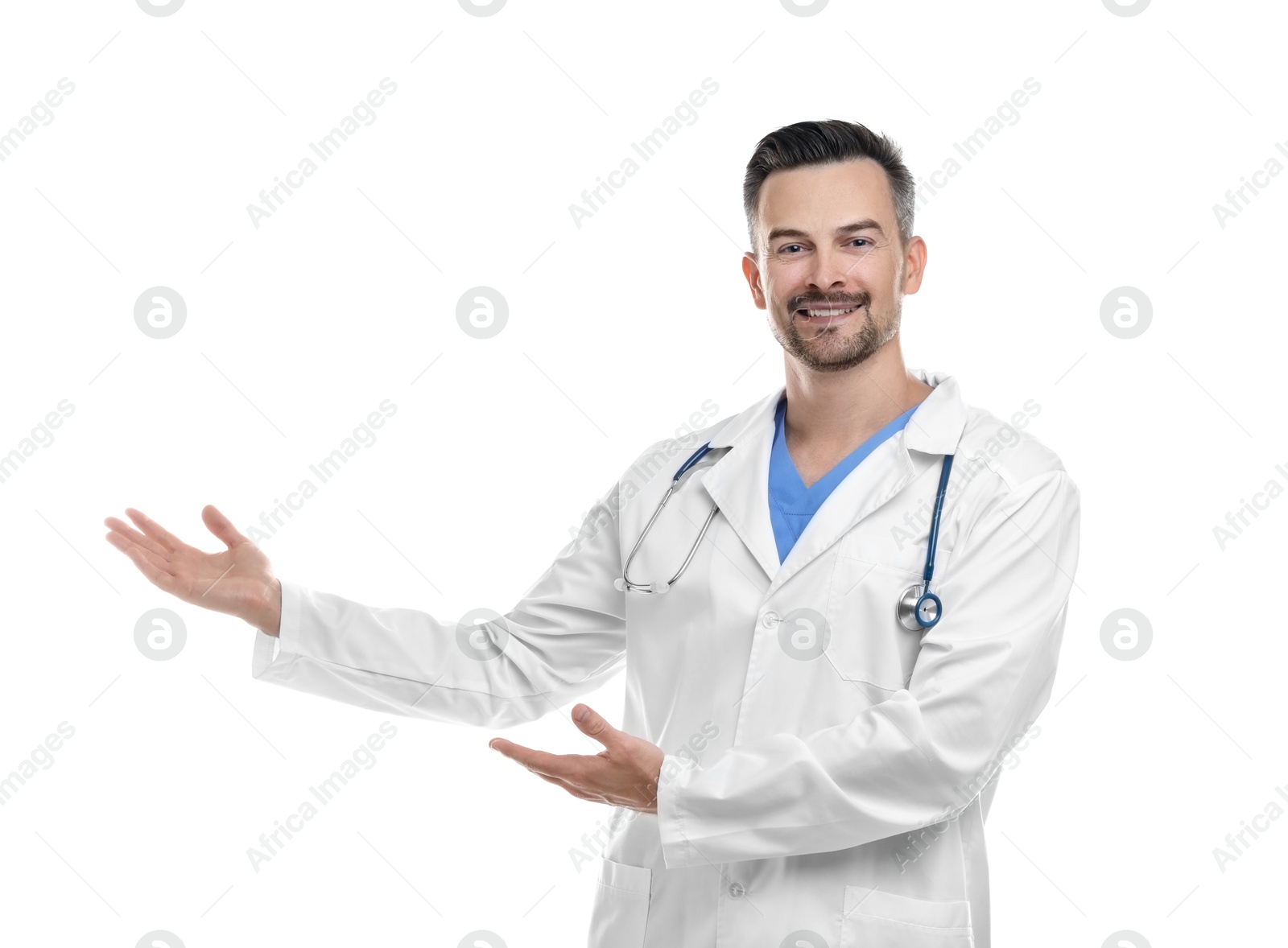 Photo of Smiling doctor with stethoscope pointing at something on white background