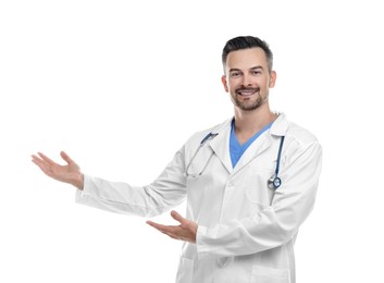 Photo of Smiling doctor with stethoscope pointing at something on white background