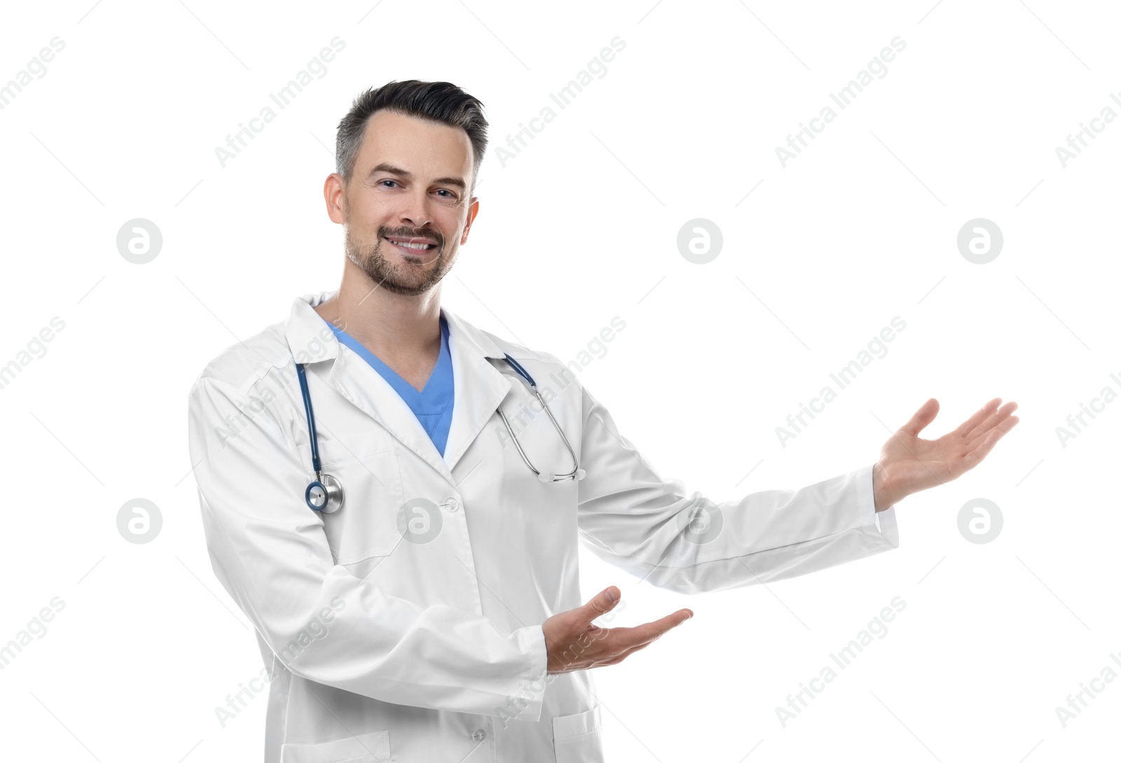 Photo of Smiling doctor with stethoscope pointing at something on white background