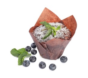 Photo of Delicious sweet muffin with powdered sugar, mint and blueberries isolated on white