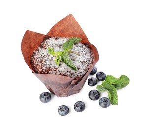 Photo of Delicious sweet muffin with powdered sugar, mint and blueberries isolated on white