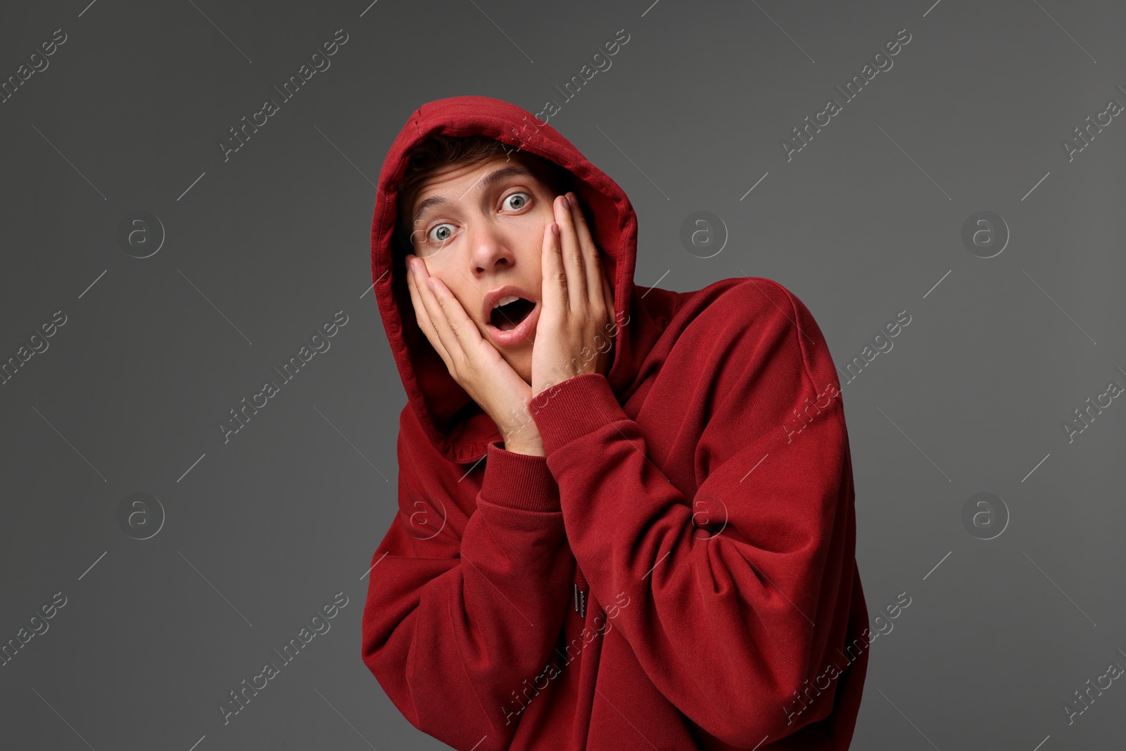 Photo of Portrait of scared young man on gray background