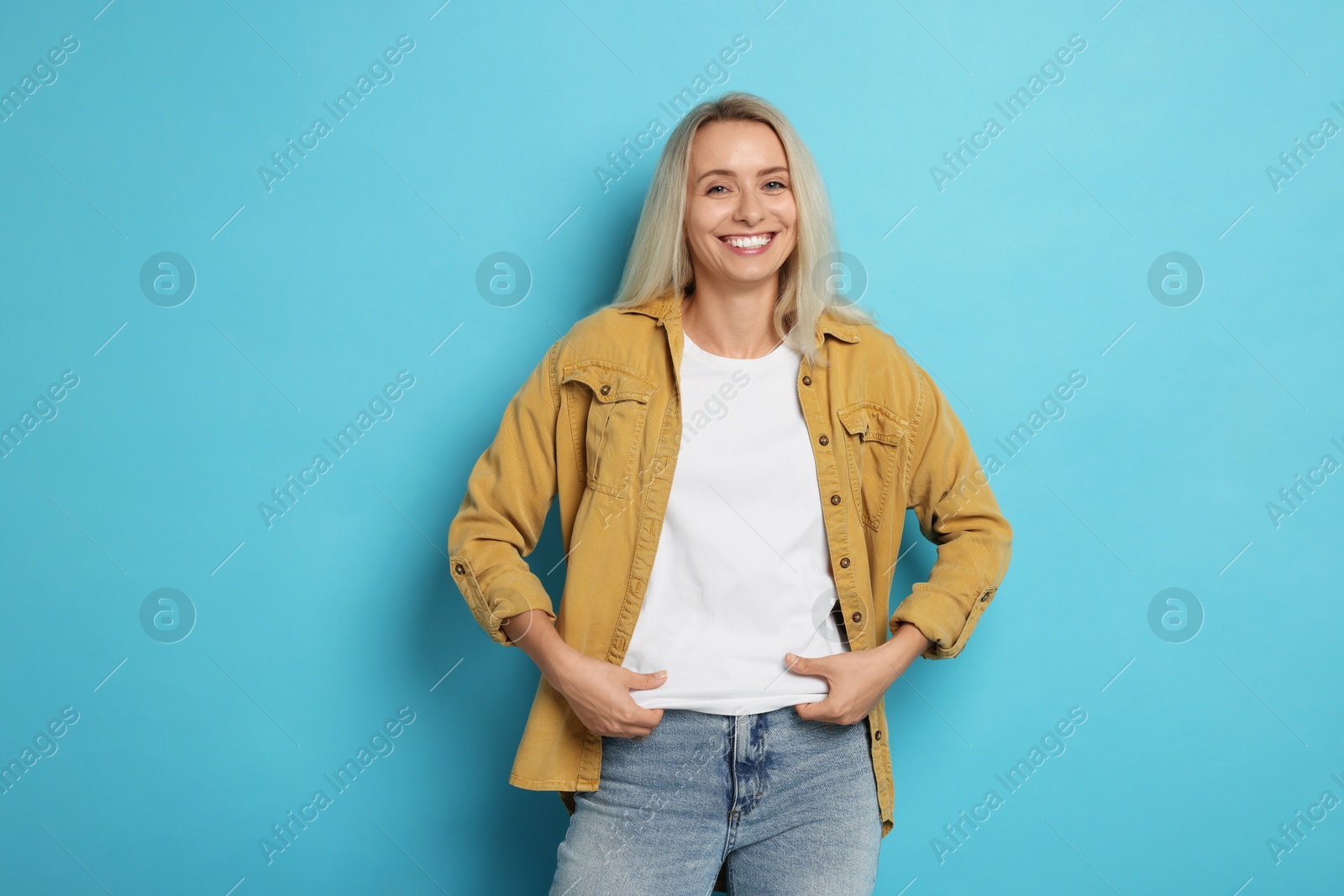 Photo of Portrait of beautiful woman on light blue background