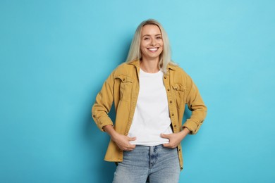 Photo of Portrait of beautiful woman on light blue background