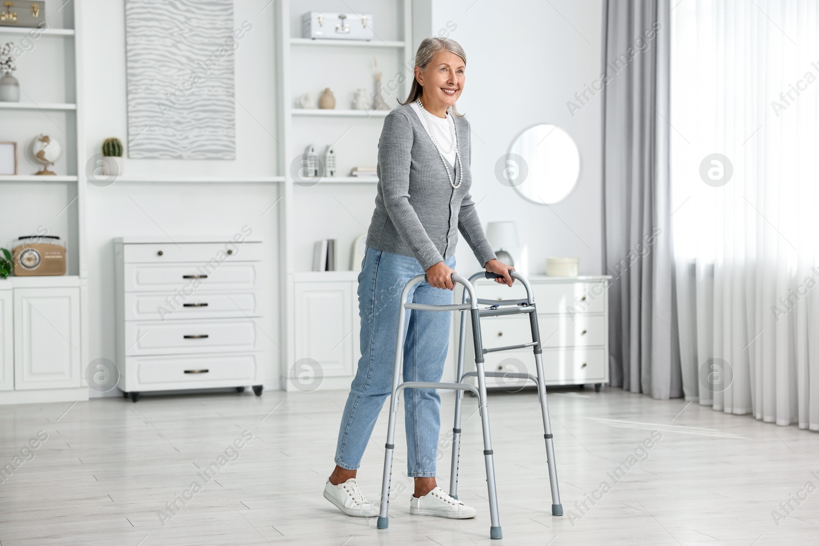 Photo of Senior woman with walking frame at home