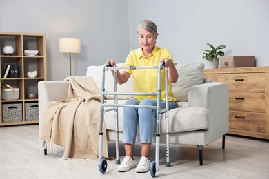 Senior woman with walking frame on sofa at home