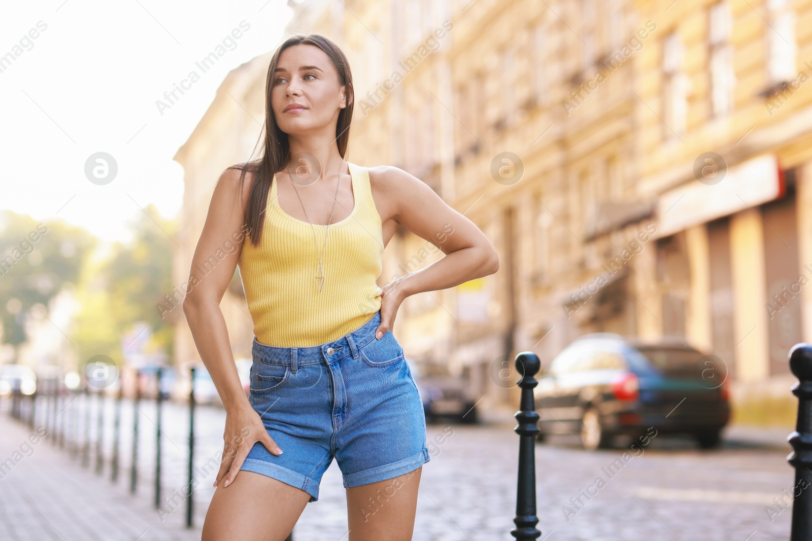 Photo of Beautiful woman wearing stylish denim shorts outdoors