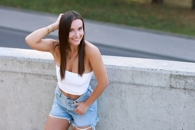 Photo of Beautiful woman wearing stylish denim shorts outdoors